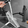 A hand is using a detachable broom with a double-sided silicone scraper to clean a surface.