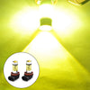 A bright yellow LED fog light bulb illuminating a surface, with two replacement bulbs shown below.