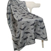 A gray flannel throw blanket printed with black bats draped over a white hanger.