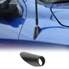 Close-up of a black carbon fiber antenna base cover installed on a blue Dodge RAM 1500 vehicle.