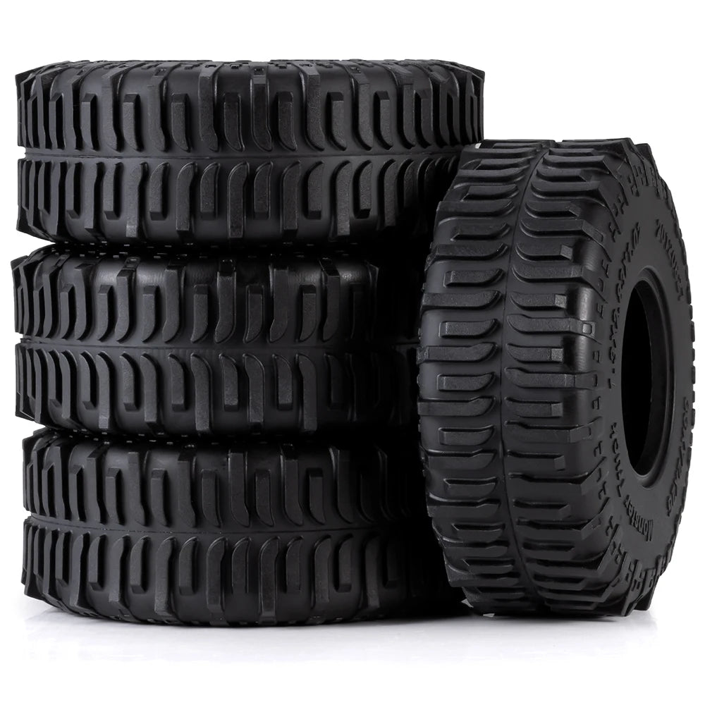 A stack of four black mud terrain rubber tires for RC crawlers.