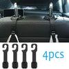 Four black universal car headrest hooks used as storage hangers for bags and clothes