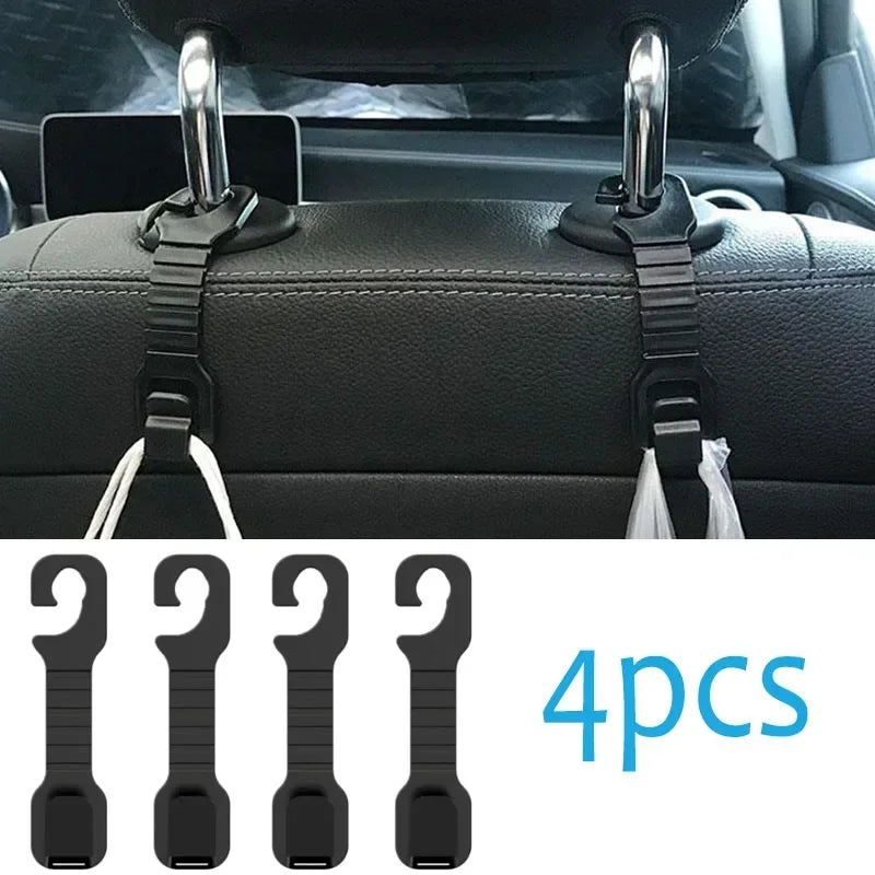 Four black universal car headrest hooks used as storage hangers for bags and clothes