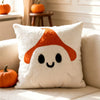A white plush throw pillow cover featuring an orange pumpkin design.