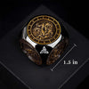 A black metal spinner dice cube featuring a gold-colored dragon design and numbered faces.