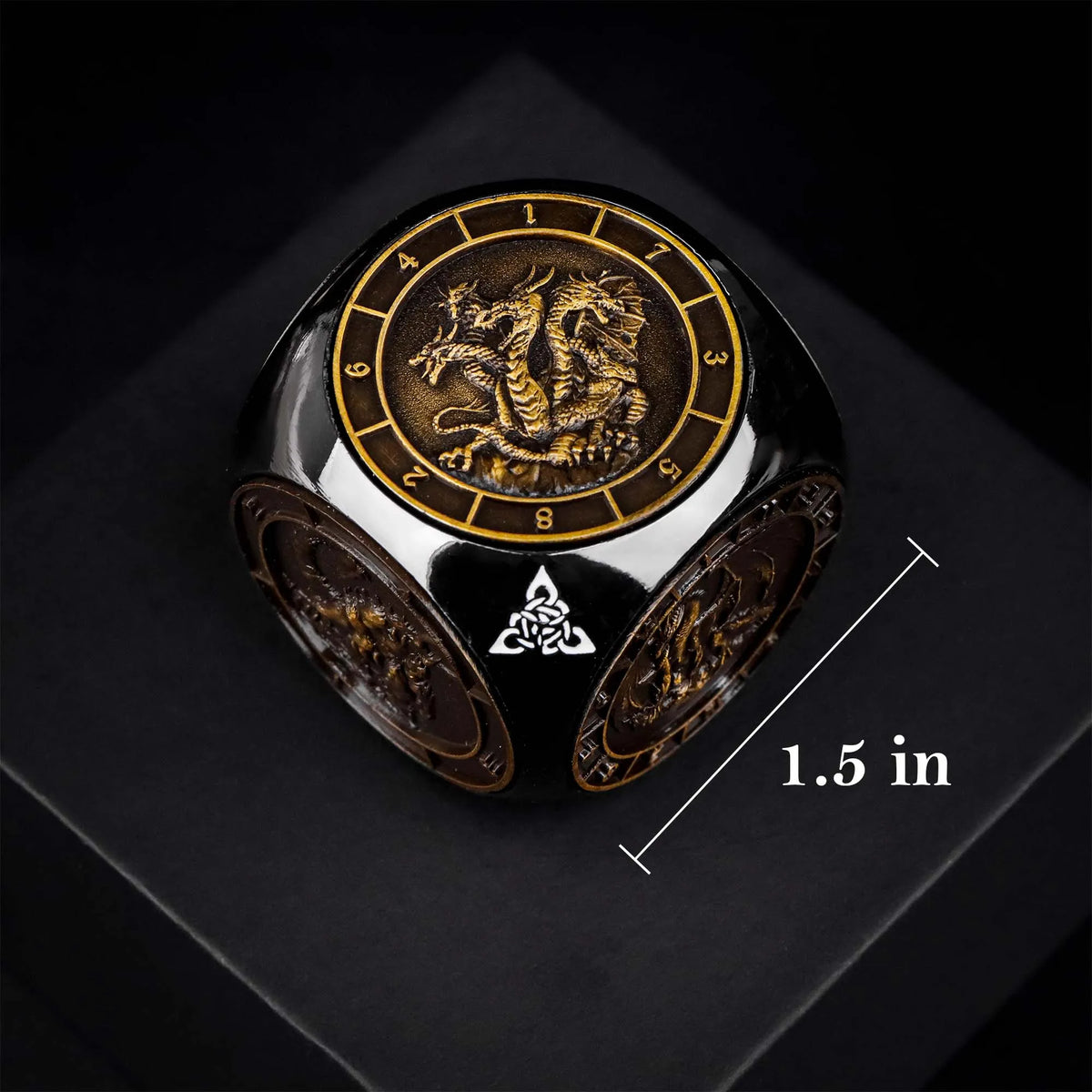 A black metal spinner dice cube featuring a gold-colored dragon design and numbered faces.
