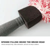 A close-up of a black sponge filling inside a cleaning brush head with a pink and white fluffy bristles.