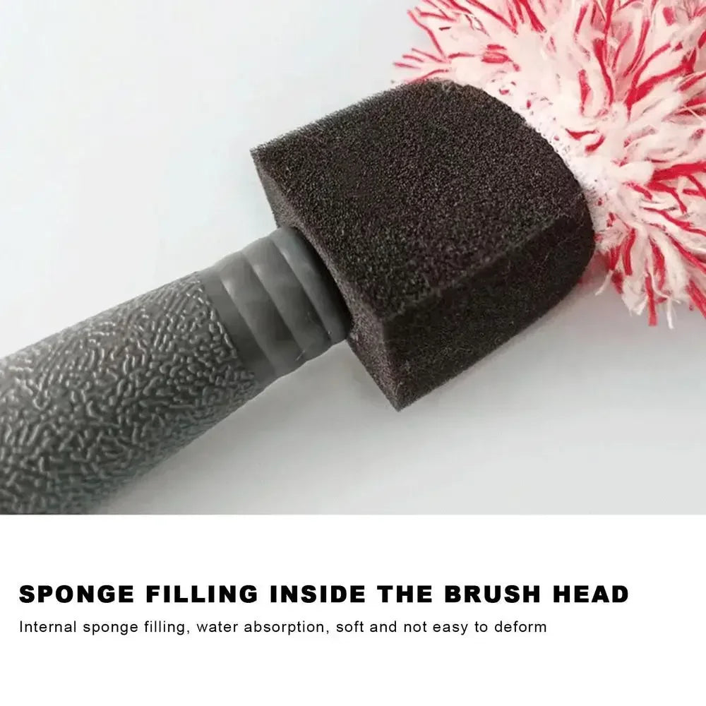 A close-up of a black sponge filling inside a cleaning brush head with a pink and white fluffy bristles.