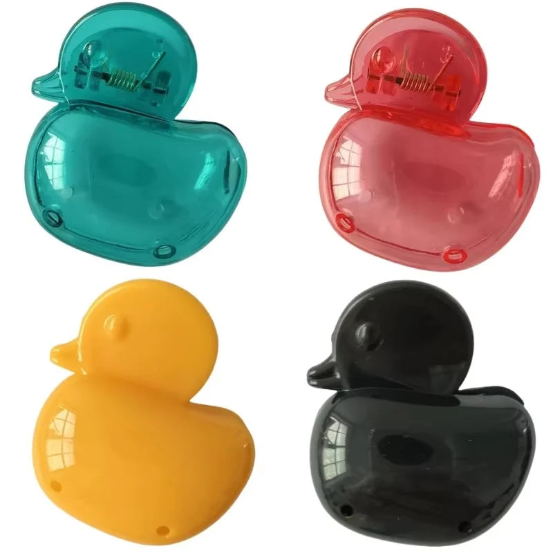 A set of four silicone toothbrush head covers in teal, pink, yellow, and black.