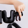 A hand is shown gripping a black 2-in-1 stroller cup holder and phone mount device.