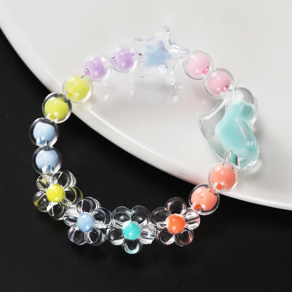 A bracelet made of heart-shaped acrylic beads in pastel colors, including purple, pink, and blue shades.