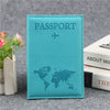 A teal leather passport holder featuring a light blue world map design and a small airplane icon.