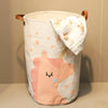 A light pink and white folding cartoon print baby storage basket with a unicorn design.