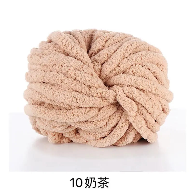 A ball of light beige chunky acrylic yarn used for knitting and crochet projects.