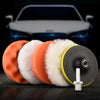 A set of six orange and white polishing sponge pads for car scratch removal displayed on a dark surface.