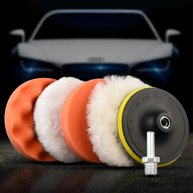 A set of six orange and white polishing sponge pads for car scratch removal displayed on a dark surface.