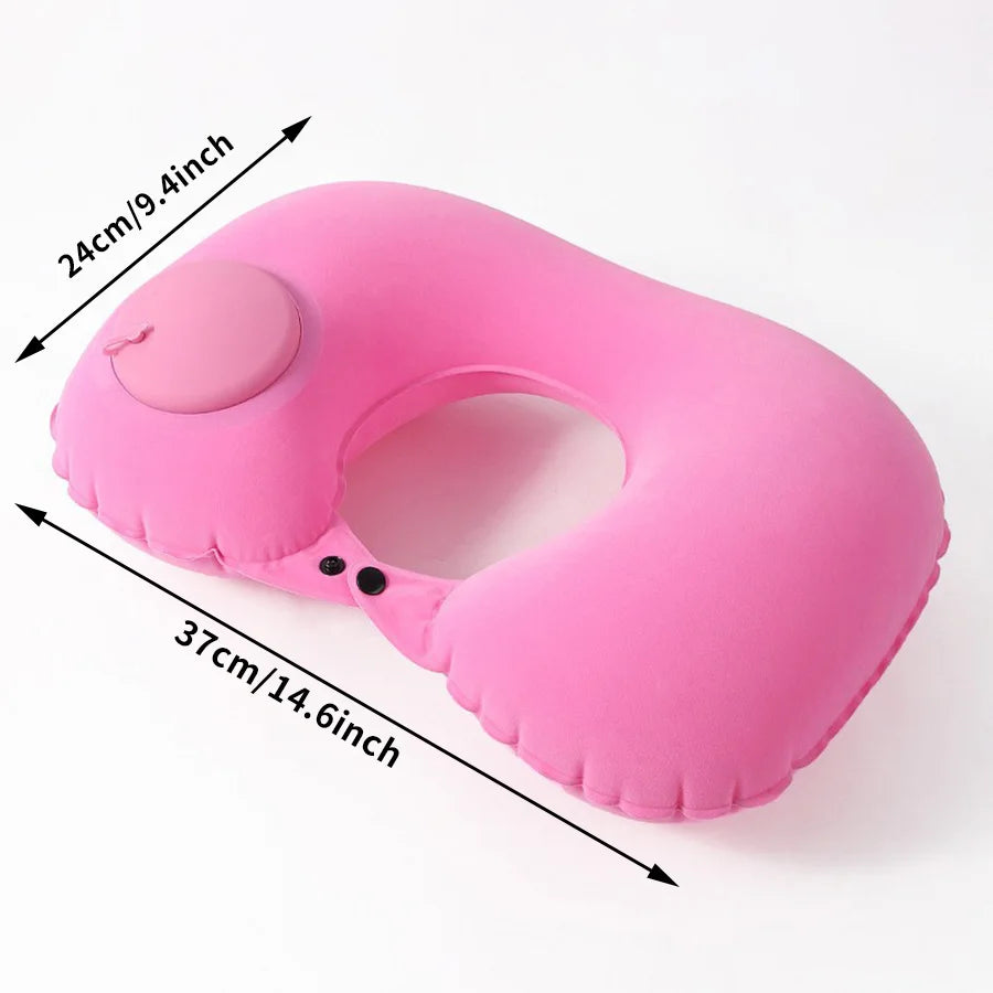 A pink self-inflating travel neck pillow with a soft flocking cover shown from the side.