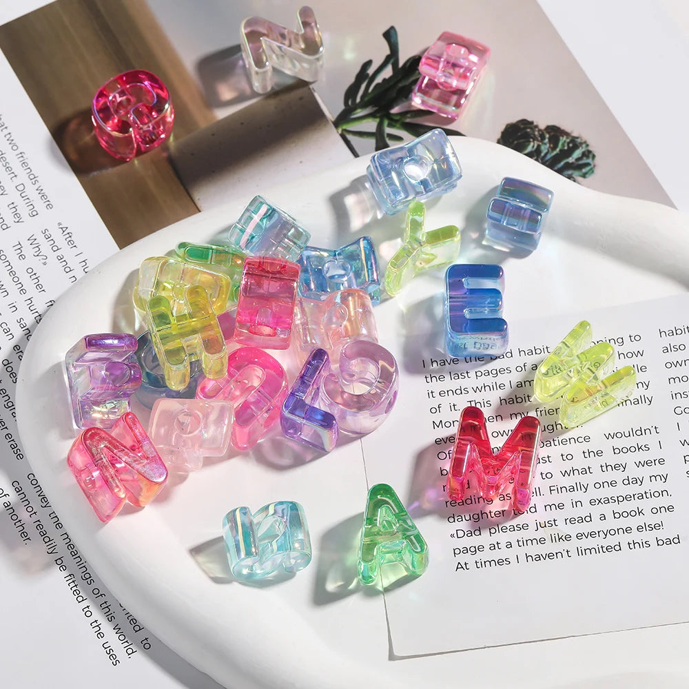 A collection of colorful acrylic alphabet beads in various shades and shapes arranged on a white plate.