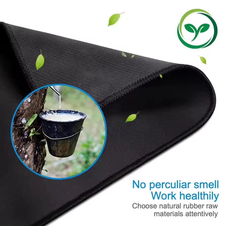 Black stitched-edge non-slip mouse pad showing a cup of liquid being poured onto a tree trunk.