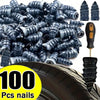 A pile of 100 black tire repair nails next to a tire tread and a single nail.