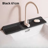 Black 61cm foldable silicone faucet splash mat with a curved faucet and soap dish installed in a white sink.