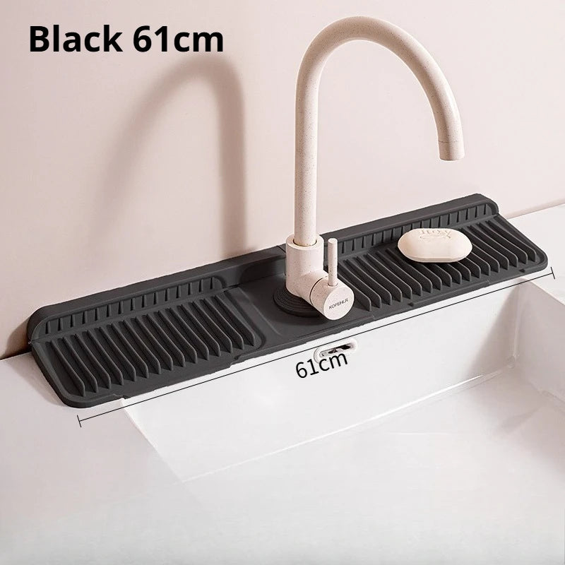 Black 61cm foldable silicone faucet splash mat with a curved faucet and soap dish installed in a white sink.
