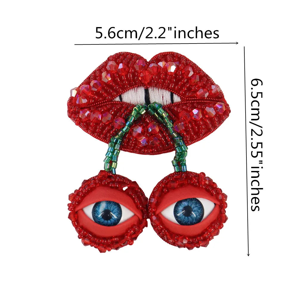 A pair of sparkling red rhinestone patches shaped like lips and eyes for clothing and DIY crafts.