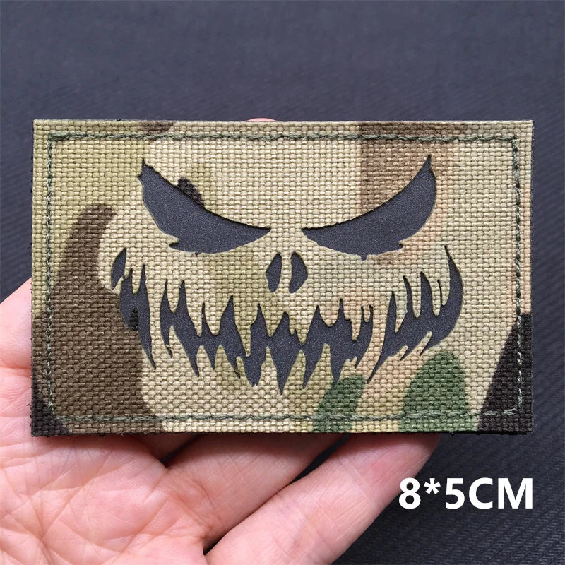 A close-up of a tactical patch featuring a menacing skull design on a camouflage background.