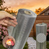 A hand holds a roll of 304 stainless steel mesh screen for windows and ventilation against an orange sunset backdrop.