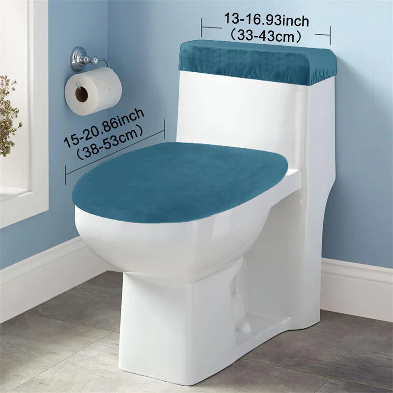 A white toilet seat and tank cover set with a teal blue cushion and a roll of toilet paper visible on a light blue wall.