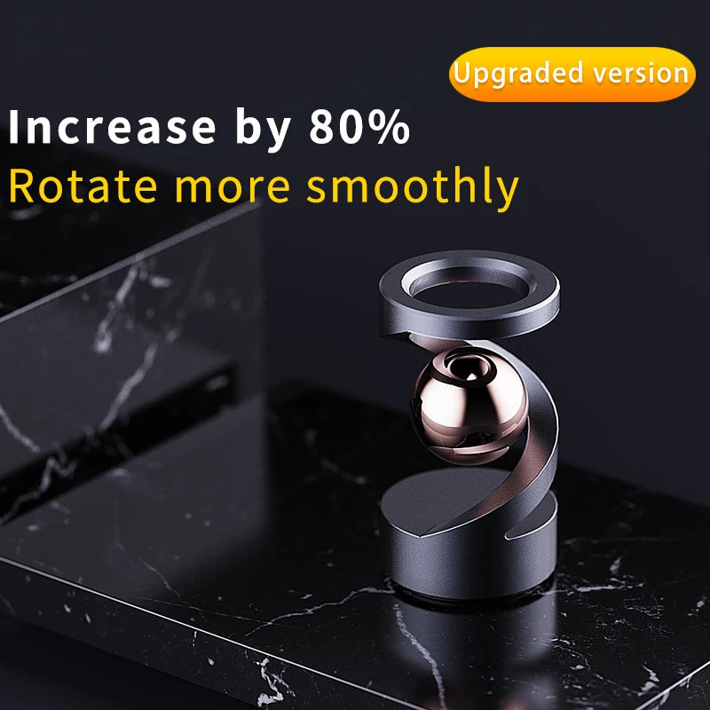 A close-up of a polished metal magnetic levitating spinning top on a dark marble surface.