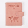 A pink leather passport holder featuring a world map design and the word PASSPORT printed on the cover.