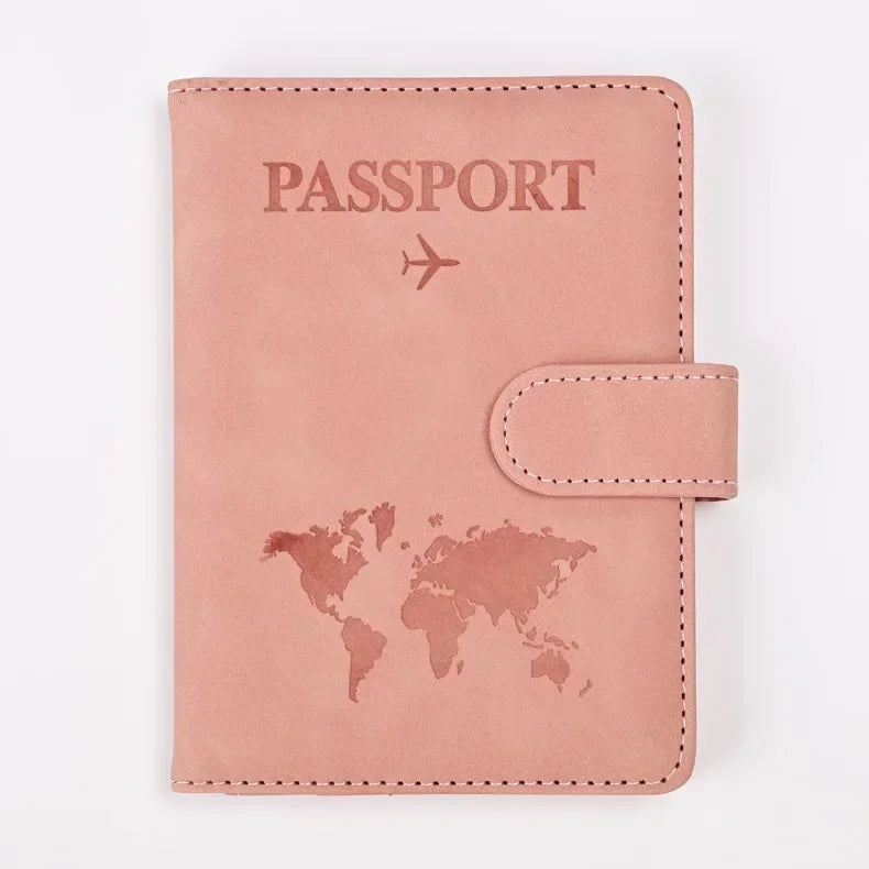 A pink leather passport holder featuring a world map design and the word PASSPORT printed on the cover.