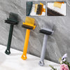 Three hairbrushes in black, yellow, and gray with rake teeth displayed against a gray marble background.