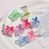 A collection of colorful acrylic alphabet beads in various shapes and sizes displayed on a white plate.