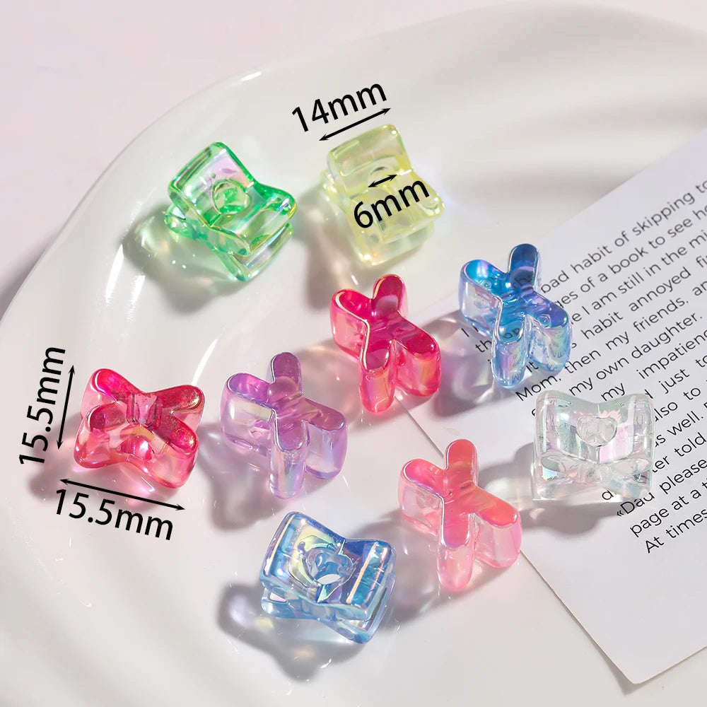 A collection of colorful acrylic alphabet beads in various shapes and sizes displayed on a white plate.