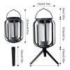 A black solar flickering flame lantern with a hanging design and a separate light bulb.