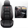 Black leather car seat cover with red stitching and embossed design shown in a close-up view.