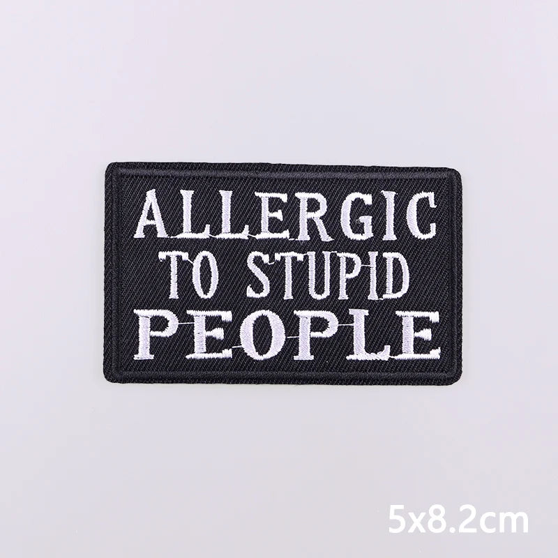 Black embroidered patch with white text that reads Allergic to Stupid People
