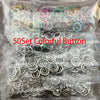 A clear plastic bag containing a 50 set of colorful and silver metal buttons for clothing and DIY projects.
