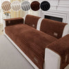 A brown ribbed sofa cushion cover with white trim and decorative fabric swatches shown on a white sofa.