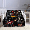 A black and white printed flannel throw blanket featuring the Kiss band logo and imagery.