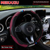 A maroon carbon fiber steering wheel cover for a car, shown in the interior context.