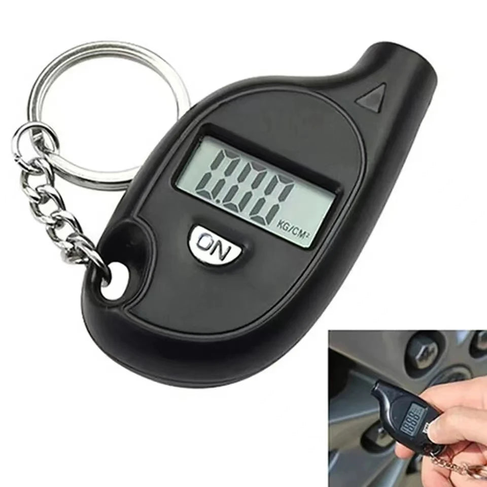 A black digital tire pressure gauge with an LCD display and metal chain for measuring air pressure.