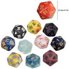 A collection of ten polyhedral dice in various colors and shapes including a red d20, yellow d10, black d12s, and others.