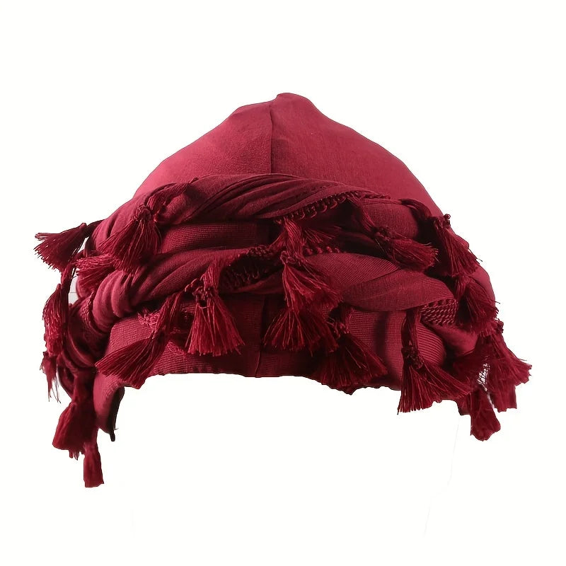 A deep maroon vintage twist head wrap with fringed tassels shown flat.