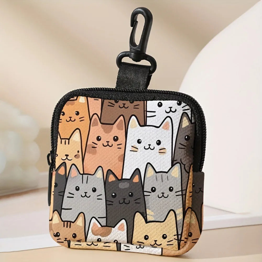 A black mini coin purse featuring a collage of various cat faces in earthy tones.