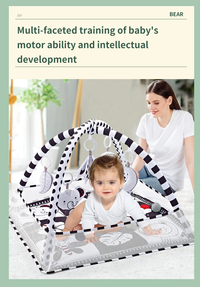 A woman is demonstrating a multi-faceted training of baby's motor ability and intellectual development using a play gym mat w