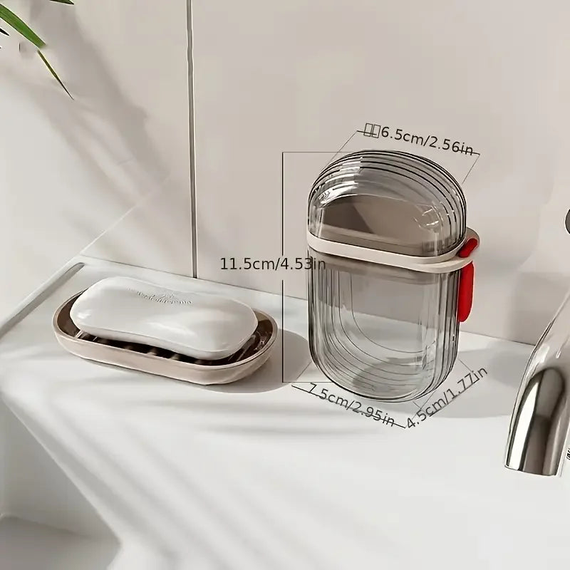 A clear plastic portable travel soap box with a drainage lid and a white soap bar resting on a tray.