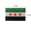 A rectangular embroidered flag patch featuring horizontal stripes of green, white, and black with three red stars.